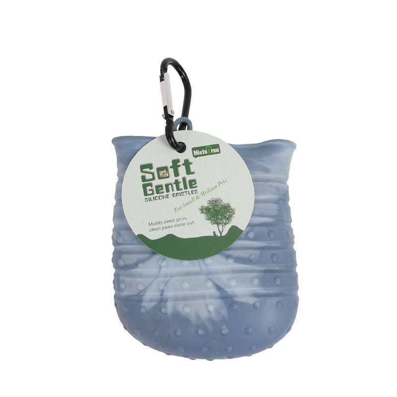Blue dog paw brush with a carabiner and 'Soft Gentle' label on a white background