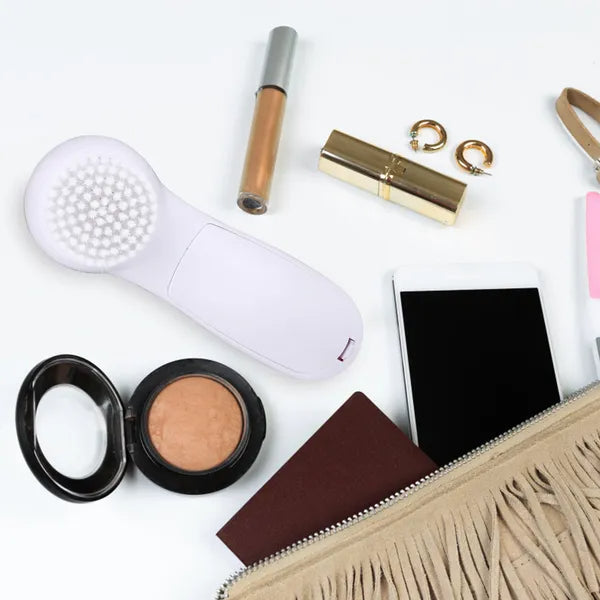 Compact facial cleansing brush designed for travel and everyday use